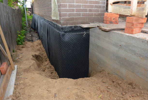 SJ Waterproofing Pros technician performing targeted Wet Basement Repair assessment in Independence, MN